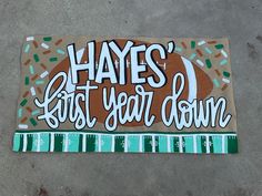 a sign that says, hayes first year down on the ground with sprinkles