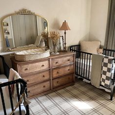 a baby's room with two cribs and a dresser