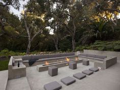 an outdoor seating area with benches and fire pit