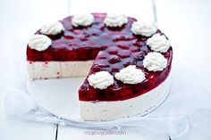 a cheesecake with berries and whipped cream on top