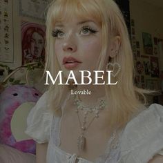 a woman with blonde hair and blue eyes is wearing jewelry that reads mabel lovable