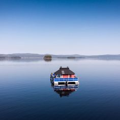 a house boat floating on top of a lake