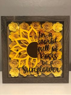 a shadow box with yellow flowers and a quote on it