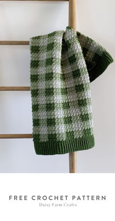 a green and white scarf hanging on a ladder with the text free crochet pattern