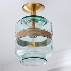 a glass light fixture hanging from the ceiling