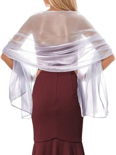 the back of a woman wearing a dress with sheer sleeves and a long skirt on it