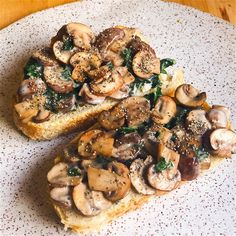 two pieces of bread with mushrooms on them