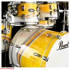 a yellow and white drum set with the words learn to play drums on it's side