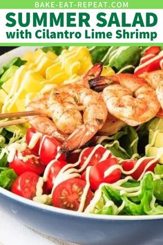 a salad with shrimp, tomatoes and lettuce is shown in a bowl on the table