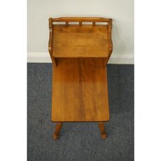 a small wooden table sitting on top of carpeted floor