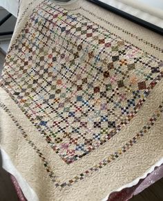 an old quilt is on display in a room