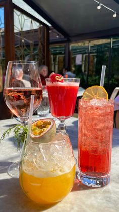 three different types of drinks on a table