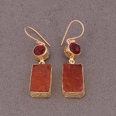 "Feel the vibrant energy of this earring inspired by \"Agni\" or fire we have handmade this dangle earring. Natural high quality carnelian stone is moulded in gold plated brass work to give lustre and shine to the design. The gold detailing and the delicate hook enhance and allow flexibility to the design. Comfortable to wear throughout the day this earring will be transition seamlessly for any occasion; and a pretty little gift for Christmas. One-of-a-Kind Earrings, Natural Raw Stone Earrings, Earring Inspired, Black Tourmaline Ring, Raw Stone Earring, Carnelian Earrings, Natural Stone Earrings, Holiday Earrings, Carnelian Stone, Vibrant Energy, Natural High