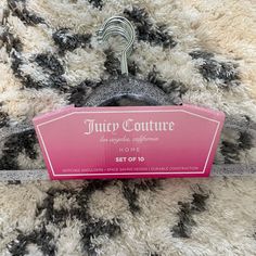 a pink sign sitting on top of a pile of black and white fur covered floor