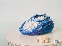 a blue and white rock sitting on top of a table