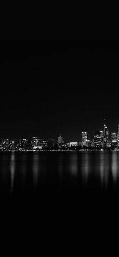 black and white photograph of city skyline at night