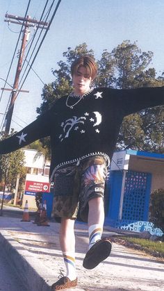 a young man riding a skateboard down a street