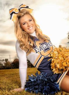 a cheerleader posing for a photo with her pom poms