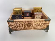 a wooden box filled with books on top of a table