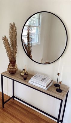 a mirror and some plants on a table