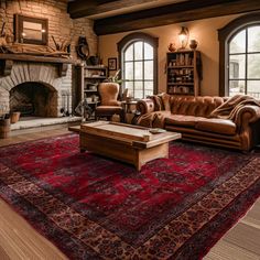 a living room filled with furniture and a large rug on the floor next to a fire place