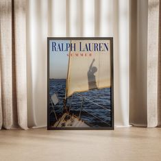 a book sitting on top of a wooden table next to a window with drapes