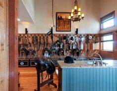 a kitchen with lots of utensils hanging on the wall