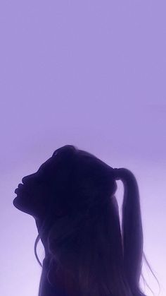 the silhouette of a woman with long hair