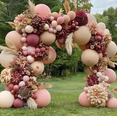 two large balloons are decorated with flowers and plants