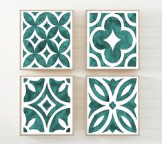 four blue and white tile designs on a wall