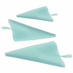 three pieces of light blue plastic on a white background, with one piece missing from the top