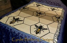 a crocheted blanket with two bees on it and the words, cuddle birdsong designs