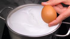 an egg is being boiled in a saucepan