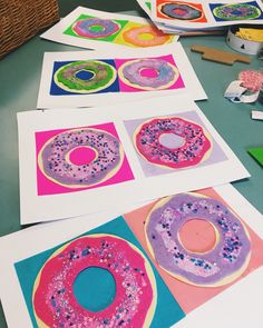 paper plates with doughnuts on them are sitting on the table next to some crafting supplies