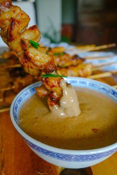 skewers of food are being served in a bowl