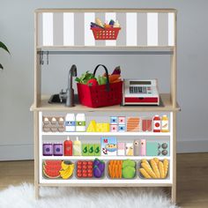 a toy kitchen with fruits and vegetables on it