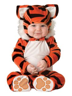 a baby dressed in a tiger costume