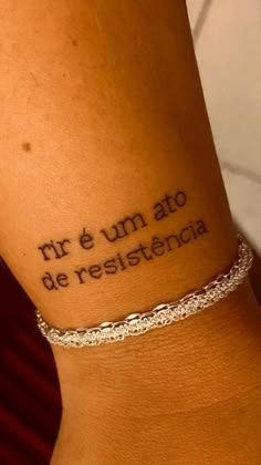 a woman with a tattoo on her arm that reads, mr e'm ato de resistencecia