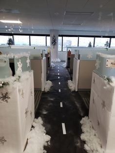 an office decorated for christmas with snowflakes on the desks and white boxes