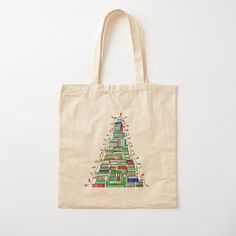 a tote bag with a christmas tree made out of books