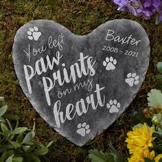 a heart shaped stone with paw prints and my heart written on it surrounded by flowers