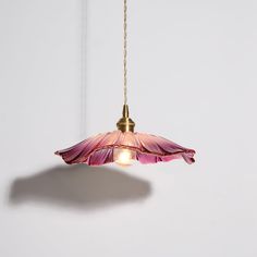 a pink flower light hanging from a chain