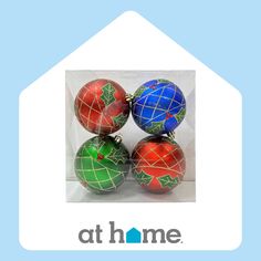 four christmas ornaments are sitting in a clear plastic box with the words at home on it