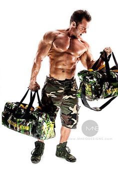 a shirtless man holding two duffel bags in one hand and another bag in the other