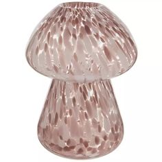 a pink glass vase sitting on top of a white table