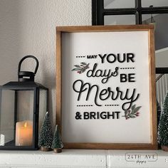 a framed sign that says may your days be merry and bright next to some christmas trees