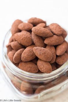 a glass bowl filled with almonds on top of a table