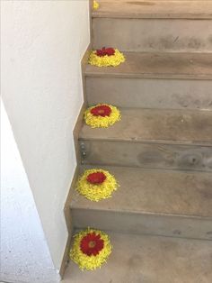 some yellow and red flowers are on the stairs