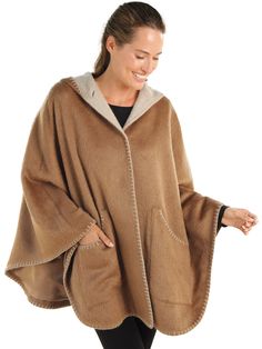 Experience true designer quality without the designer price tag. This luxurious satin-lined cape, 70% suri alpaca and 30% merino wool, wraps you in a cozy all-day caress. Contrasting light and dark Brown interior/exteriors and standout stitching at the edges add striking definition and pique interest—attracting compliments wherever you go. We’ve even added generous pockets so you can mingle with all your essentials. Made in Peru. Cozy Wool Poncho Cape, Wool Cape Shawl For Fall, Fall Wool Cape Shawl, Cozy Alpaca Poncho Cape, One Size Wool Cape Outerwear, One Size Wool Cape, Cozy Cashmere Cape, Alpaca Shawl Cape For Fall, Alpaca Shawl Outerwear For Winter