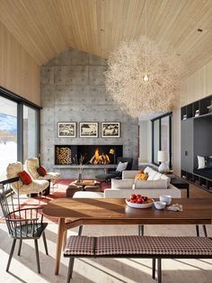 a living room filled with furniture and a fire place in the middle of it's wall